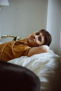 Portrait of boy lying on bed at home