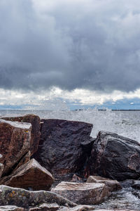 Lake superior waves crashing against rocky shoreline as storm front moves in