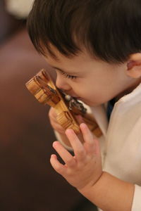 Close-up of boy kissing crucifix