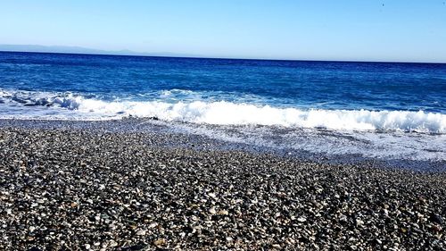 Scenic view of beach against clear sky