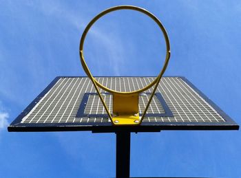 Low angle view of basketball hoop against blue sky