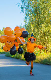 Rear view of man with balloons in park