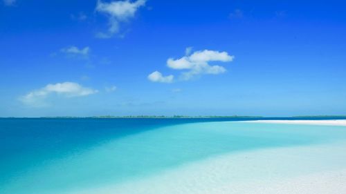 Scenic view of sea against blue sky