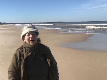 Mid adult man on beach against sky