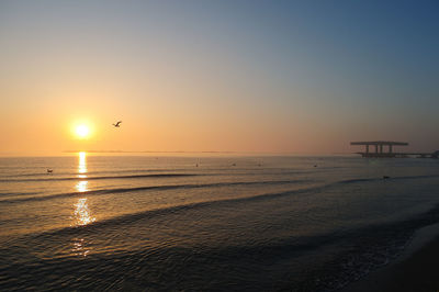 Scenic view of sea against clear sky during sunset