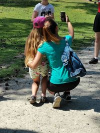 Rear view of women holding girls