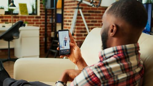 Side view of woman using mobile phone