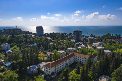 High angle view of buildings by sea against sky