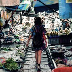 Rear view of woman standing at market