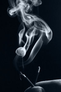 Close-up of cigarette against black background