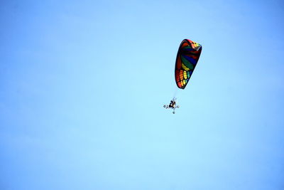 Low angle view of kite flying against clear blue sky