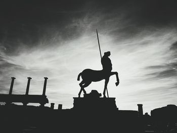 Low angle view of silhouette statue