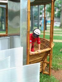 Boy looking at camera while sitting on seat