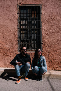 Friends sitting outside building