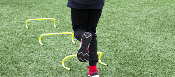 Low section of man standing on field
