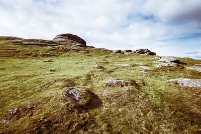 Low angle view of rocks on shore against sky