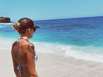 Rear view of woman looking at sea against sky