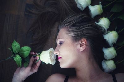Directly above shot of woman smelling rose