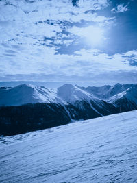 Scenic view of snow covered mountains against sky