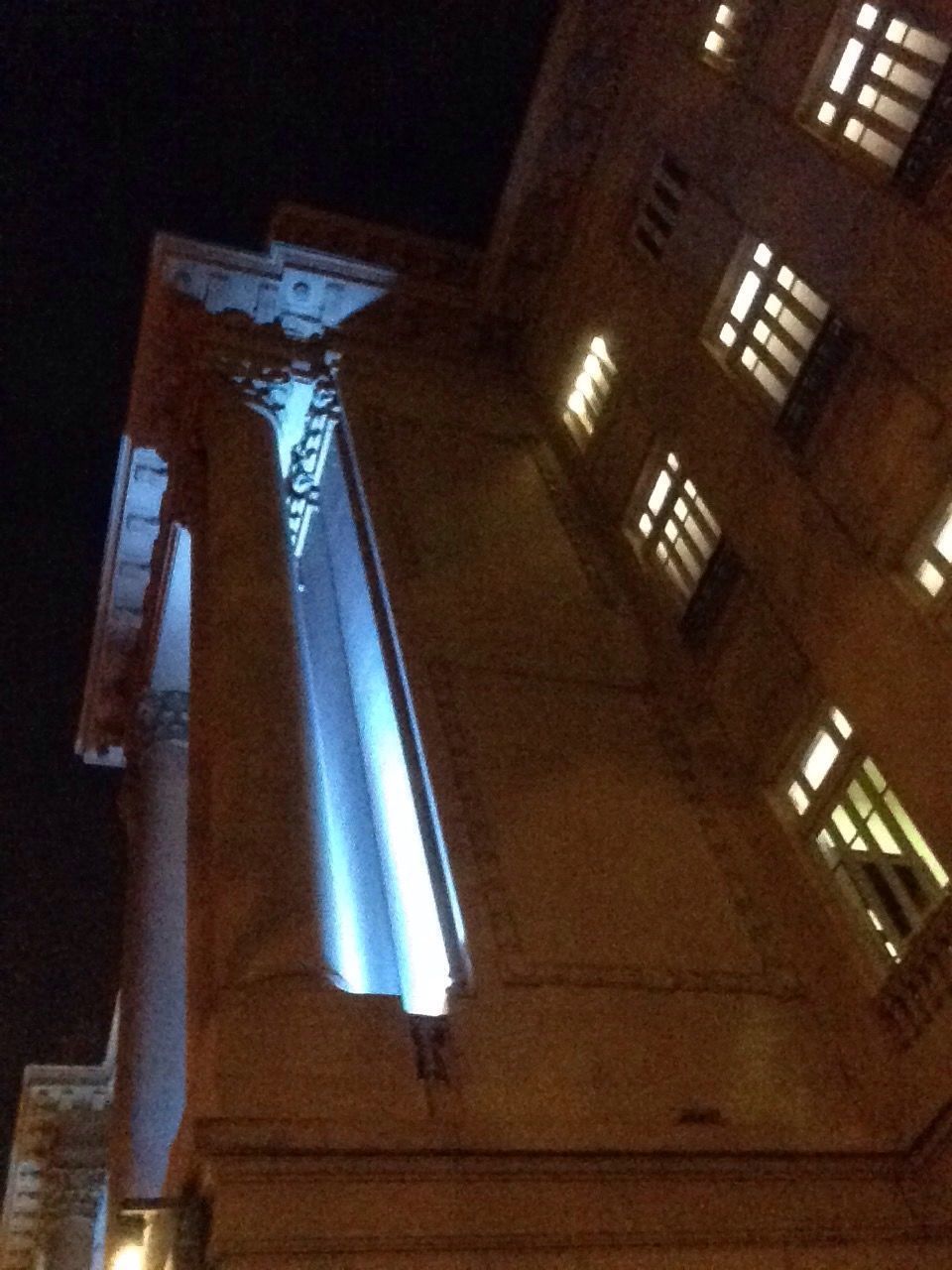 LOW ANGLE VIEW OF ILLUMINATED LIGHTS HANGING ON WALL