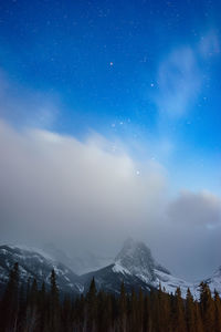 Scenic view of snowcapped mountains against blue sky