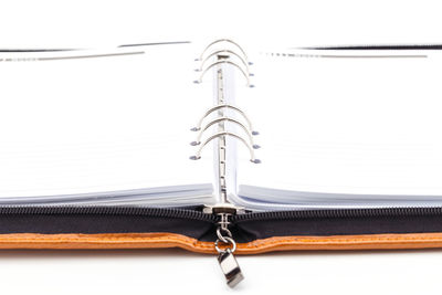 Close-up of chain hanging against white background