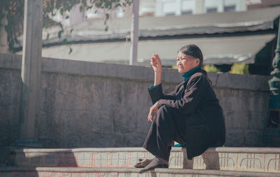 Thoughtful woman sitting on steps