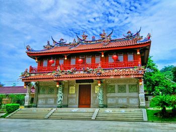 Low angle view of temple against cloudy sky