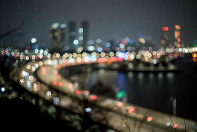 Defocused image of illuminated city at night