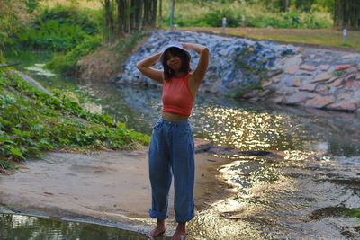 Full length of woman standing in water