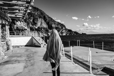 Man on beach by sea against sky