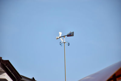 Low angle view of street light against clear blue sky
