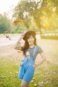 Portrait of a smiling young woman in park during autumn