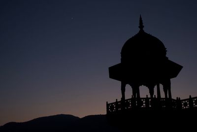 Silhouette of temple against sky at sunset