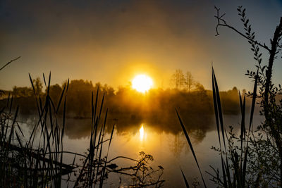 Scenic view of lake against sky during sunset