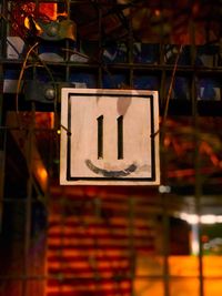 Low angle view of road sign at night