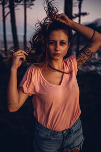 Portrait of smiling young woman standing outdoors