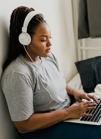 Young woman using laptop at home