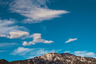 Low angle view of rock formations against blue sky