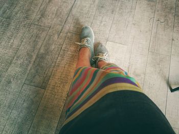 Low section of man on hardwood floor