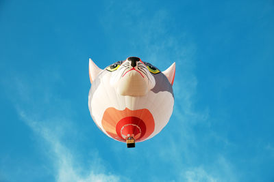 Low angle view of airplane flying against blue sky