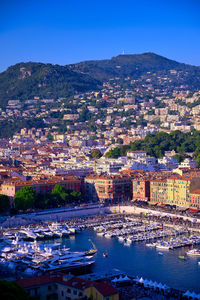 High angle view of townscape by river against sky