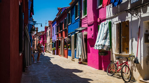 People on street amidst buildings in city