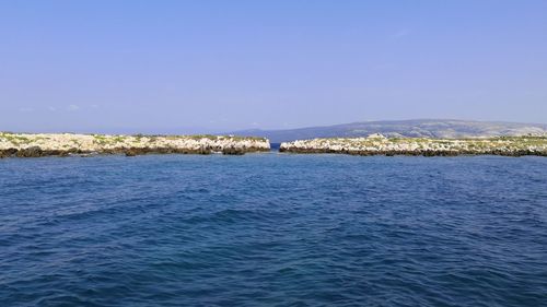 Scenic view of sea against clear blue sky