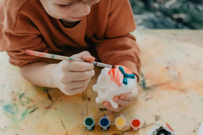 The boy draws with felt-tip pens. high quality photo