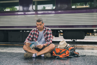 Full length of senior man sitting in bus