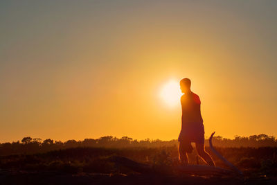 Silhouette man against sky during sunset