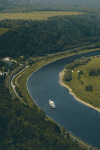 High angle view of road amidst trees on landscape