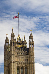 Low angle view of palace of westminster against sky in city