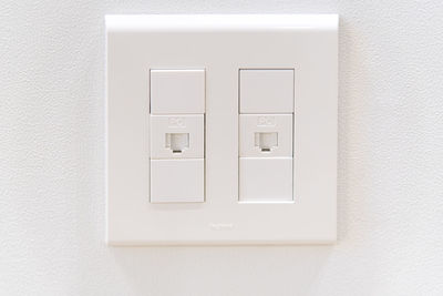 Close-up of telecommunication cable terminal on white wall